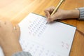 Child hands doing homework, writing capita A letter, soft focus close up Royalty Free Stock Photo