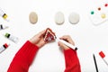 Child hands finalizing the house painting on a stone with felt pen. Royalty Free Stock Photo