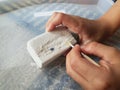 Child hands holding a brush and a chalk rock