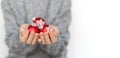 Child hands holding red Christmas balls. White background, copy space. Royalty Free Stock Photo