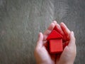 Child hands holding red model house, family, homeless, home loan and home protect insurance concept. Home sweet home Royalty Free Stock Photo