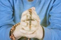 Child Hands holding rosary beads and cross while praying Royalty Free Stock Photo