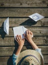 Child hands make paper boats