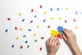 Child hands making multicolored heart on white background. Top view Royalty Free Stock Photo