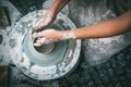 Child hands making potter bowl. Top view vertical image Royalty Free Stock Photo