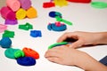 Child hands molding modeling clay or plasticine on white table Royalty Free Stock Photo