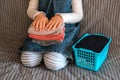 Child neatly folds a stack of clothes.