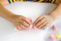 Child hands play jellys on white table Royalty Free Stock Photo