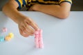 Child hands play jellys on white table Royalty Free Stock Photo