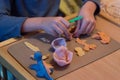 Child hands playing with colorful baby play dough, plasticine Royalty Free Stock Photo