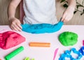 Child hands playing with colorful clay. Homemade plastiline. Plasticine. Royalty Free Stock Photo