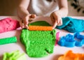 Child hands playing with blue clay. Homemade plastiline. Plasticine. play dough. Royalty Free Stock Photo