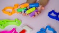 Plasticine. play dough. Child hands playing with colorful clay. Royalty Free Stock Photo