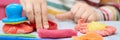 Child hands playing with colorful plasticine during quarantine Covid-19 Royalty Free Stock Photo