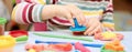 Child hands playing with colorful plasticine during quarantine Covid-19 Royalty Free Stock Photo