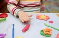 Child hands playing with colorful plasticine during quarantine Covid-19 Royalty Free Stock Photo