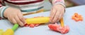 Child hands playing with colorful plasticine during quarantine Covid-19 Royalty Free Stock Photo