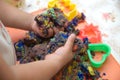 Child hands playing multicolored kinetic sand. children activity game toy for model forming craft and sculpture art Royalty Free Stock Photo