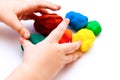 Child hands playing with play clay balls Royalty Free Stock Photo