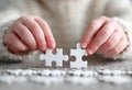 Child hands connecting white jigsaw puzzle pieces Royalty Free Stock Photo