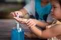 Child Hands Using Wash Hand Sanitizer Gel.