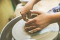 Child hands working with clay on pottery wheel Royalty Free Stock Photo