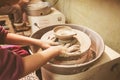 Child hands working with clay on pottery wheel Royalty Free Stock Photo