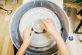 Child hands working with clay on pottery wheel Royalty Free Stock Photo