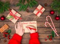 Child hands write letter to Santa. Christmas background. Concept of New year and Christmas. Top view