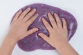 Child handson purple color slime