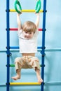 Child hanging on gymnastic rings Royalty Free Stock Photo