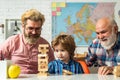 Child happy. Elderly man playing his grandson and son. Boy pupil with father and grandfather. Royalty Free Stock Photo