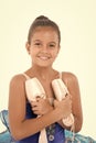 Child happy holds ballet shoes important attribute excellent ballerina. Girl ballerina holds pointe shoes in hand white
