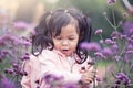 Child happy little girl running and having fun in flower field Royalty Free Stock Photo