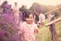 Child happy little girl running and having fun in flower field Royalty Free Stock Photo