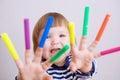 Child happy smiling sitting on floor playing with felt tip pens. baby girl painting and playing. colorful stuff felt pen caps Royalty Free Stock Photo