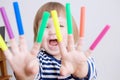 Child happy smiling sitting on floor playing with felt tip pens. baby girl painting and playing. colorful stuff felt pen caps Royalty Free Stock Photo