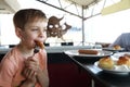 Child has breakfast in restaurant Royalty Free Stock Photo