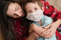 The child has the flu. the masked child measures the temperature. mother noticed a childs fever