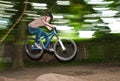 Child has fun jumping with the bike over a ramp Royalty Free Stock Photo
