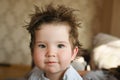 The child has hair sticking out. it`s time for the baby to get a haircut. for long hair in a child