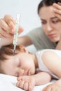 Child has a high temperature or fever, using a thermometer Royalty Free Stock Photo
