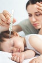 Child has a high temperature or fever, using a thermometer Royalty Free Stock Photo