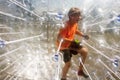 Child has a lot of fun in the Zorbing Ball Royalty Free Stock Photo