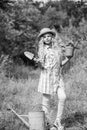 Child in hat with shoulder blade small shovel hoe. Happy smiling gardener girl. Ranch girl. Happy childhood. Planting Royalty Free Stock Photo