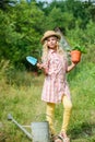 Child in hat with shoulder blade small shovel hoe. Happy smiling gardener girl. Ranch girl. Happy childhood. Planting Royalty Free Stock Photo