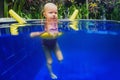 Child have a swimming lesson on polyfoam noodle in pool