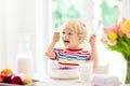 Child eating breakfast. Kid with milk and cereal Royalty Free Stock Photo