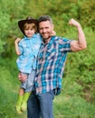 Child having fun cowboy dad. Rustic family. Growing cute cowboy. Small helper in garden. Little boy and father in nature Royalty Free Stock Photo