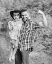 Child having fun cowboy dad. Rustic family. Growing cute cowboy. Small helper in garden. Little boy and father in nature Royalty Free Stock Photo